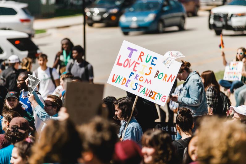 Wesleyan Churcn on Verge of Compromise with LGBTQ Agenda. Sign says "True love is born from understanding"